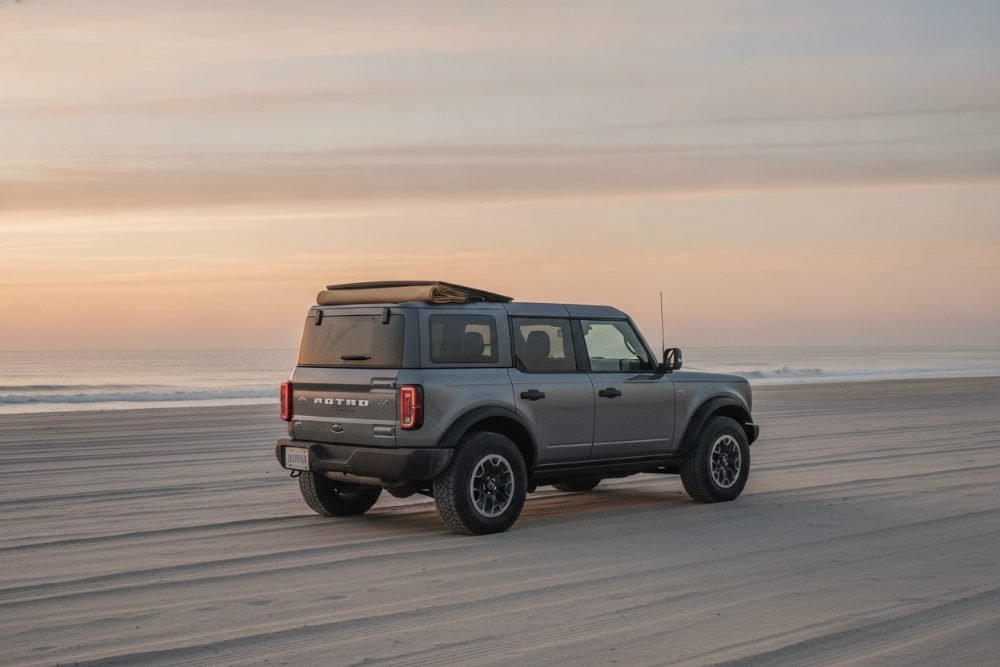 Ford Bronco on the beach at sunrise